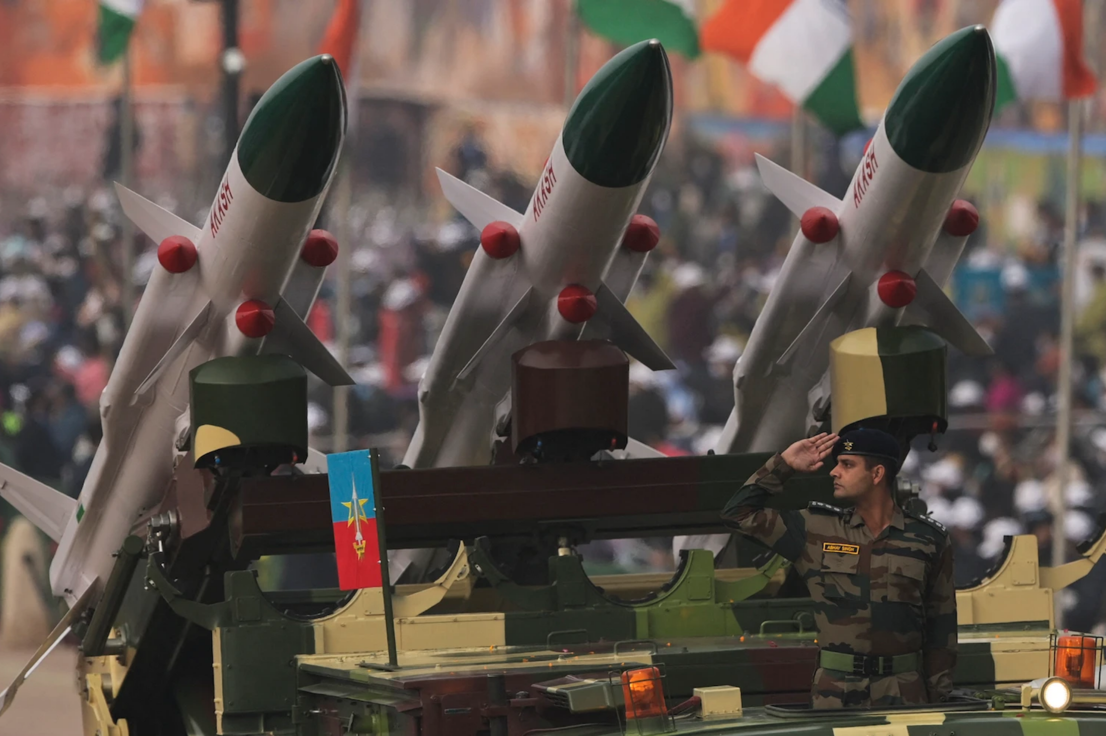 Soldier salutes next to an Akash missile system