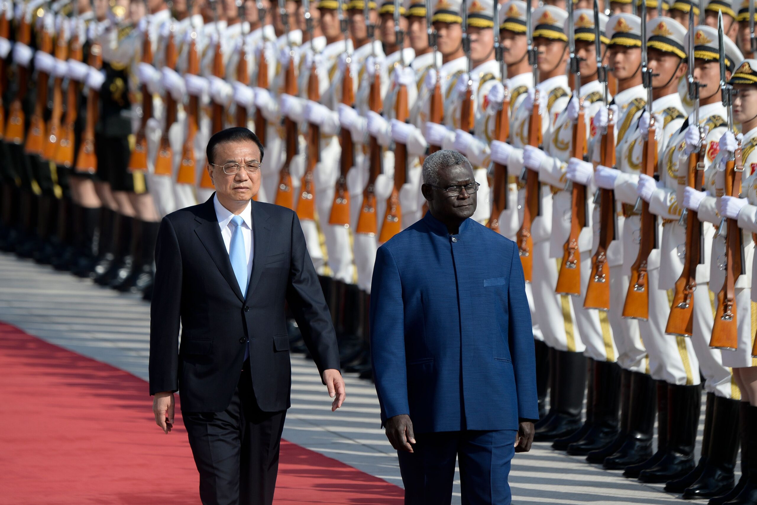 Solomon Islands Prime Minister Manasseh Sogavare and Chinese Premier Li Keqiang inspect honour guards during a welcome ceremony at the Great Hall of the People in Beijing