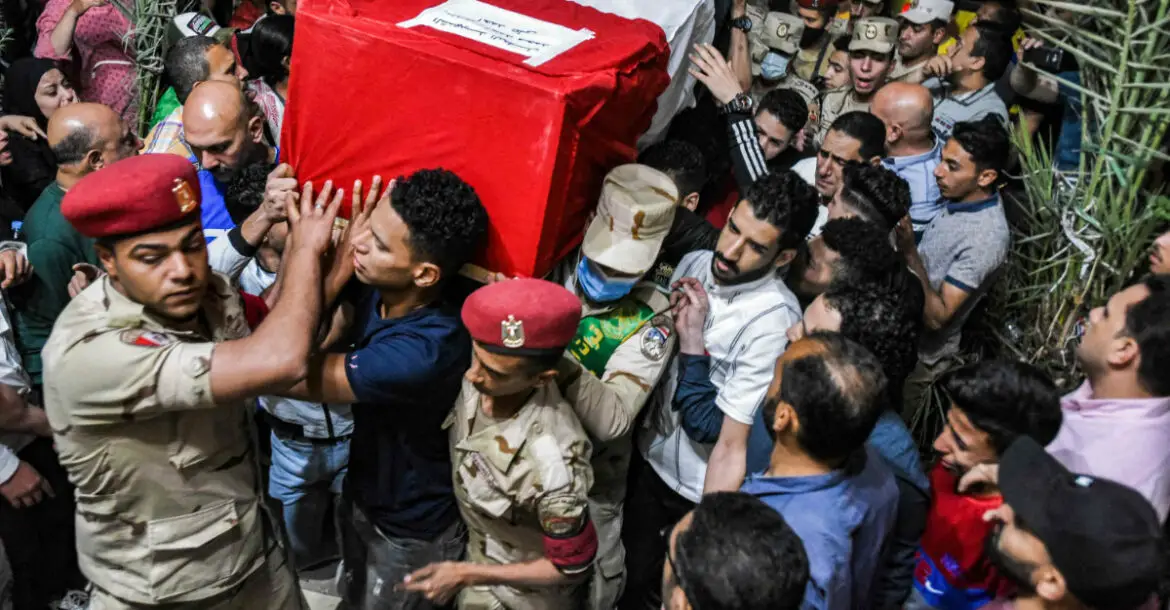 Mourners and soldiers carry the casket of one of 11 Egyptian soldiers killed in an attack