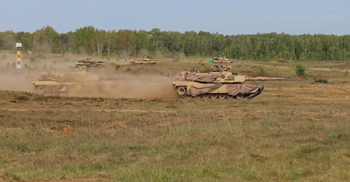 M1A2 Abrams tanks advance onto the battlefield during DEFENDER exercise