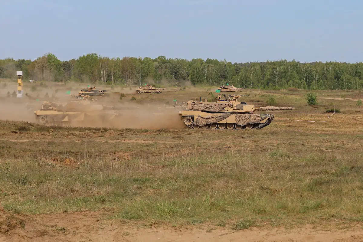 M1A2 Abrams tanks advance onto the battlefield during DEFENDER exercise