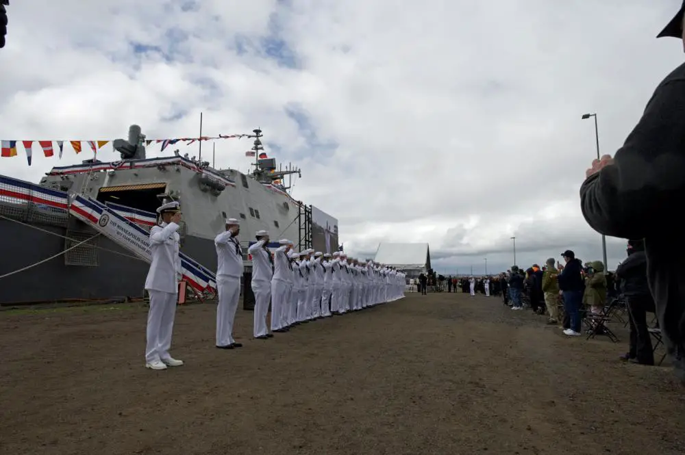 USS Minneapolis-Saint Paul Sailors salute during the commissioning ceremony of USS Minneapolis-Saint Paul (LCS 21)