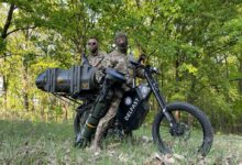 Ukrainian soldiers on a stealthy electric bike modified to carry next-generation light anti-tank weapons