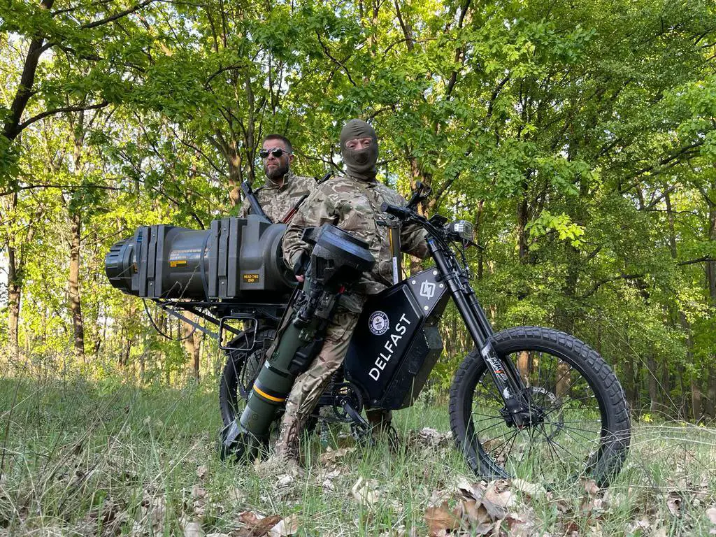 Ukrainian soldiers on a stealthy electric bike modified to carry next-generation light anti-tank weapons
