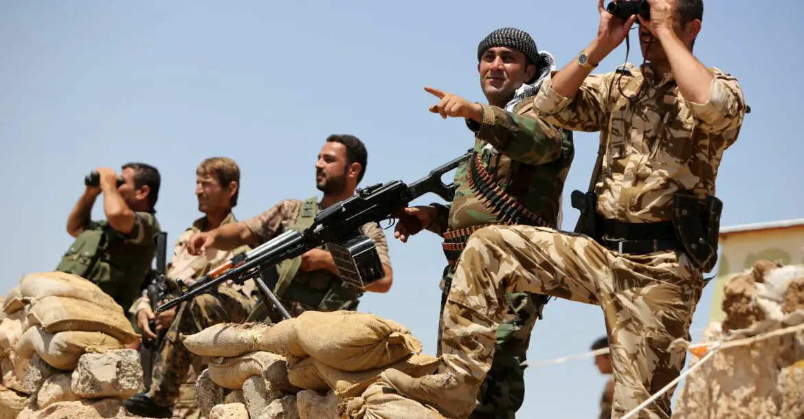 Kurdish Peshmerga fighters take up position