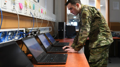 U.S. Air Force Airman client systems technician, works on a computer in a back shop at Spangdahlem Air Base, Germany.
