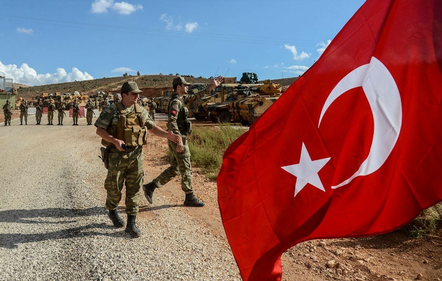 Turkish soldiers with the Turkish flag flying