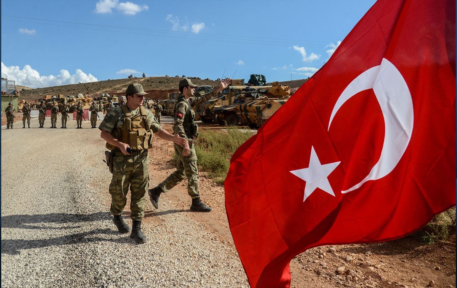 Turkish soldiers with the Turkish flag flying