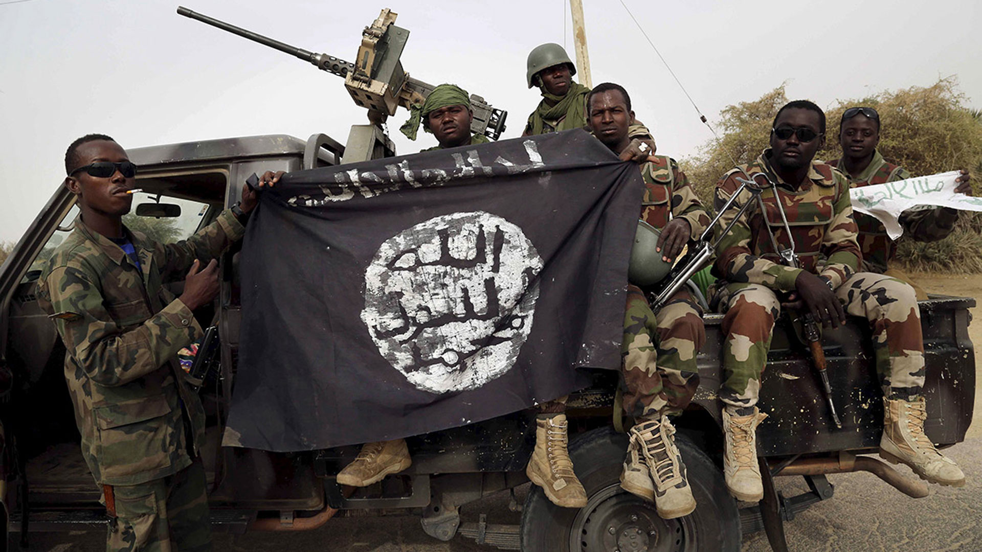 Soldiers show a Boko Haram flag