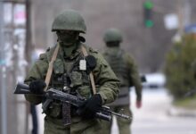 Russian soldiers patrol outside the navy headquarters in Simferopol, Crimea