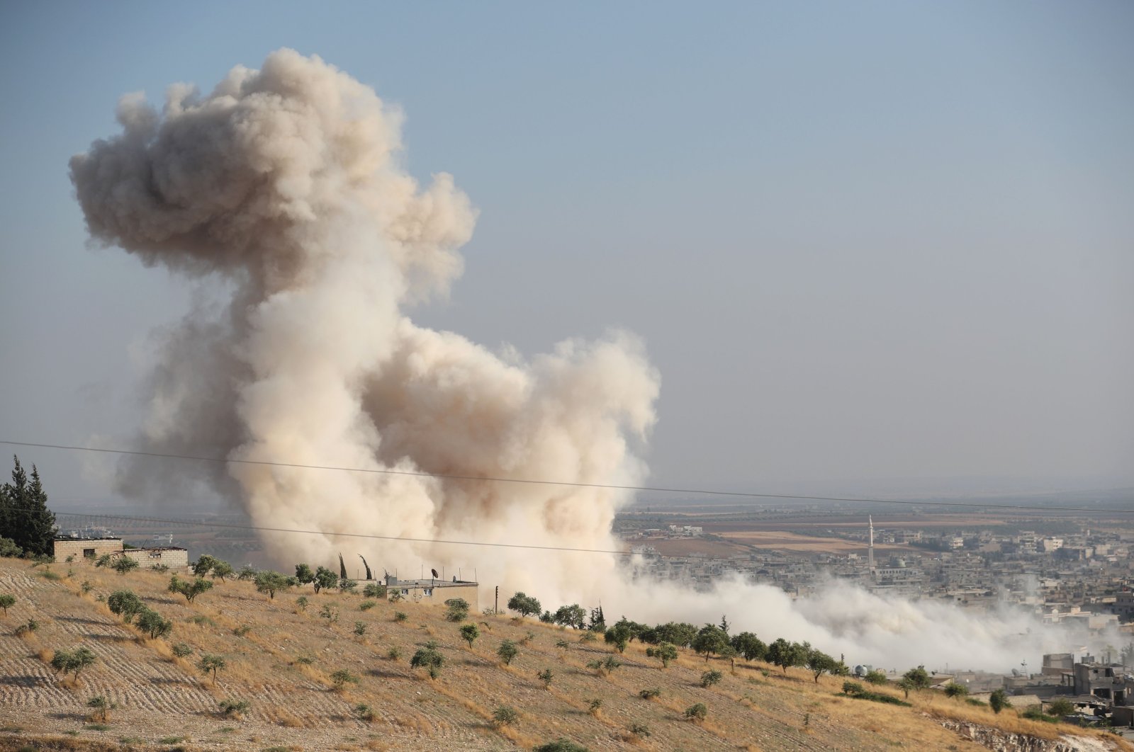 Smoke billowing above buildings during a reported airstrike by pro-regime forces on Khan Sheikhun in the south of the northwestern Syrian province of Idlib, Syria