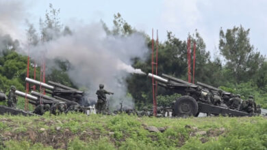 Taiwanese military soldiers fire howitzers during a live-fire anti-landing drill in Pingtung county, Taiwan