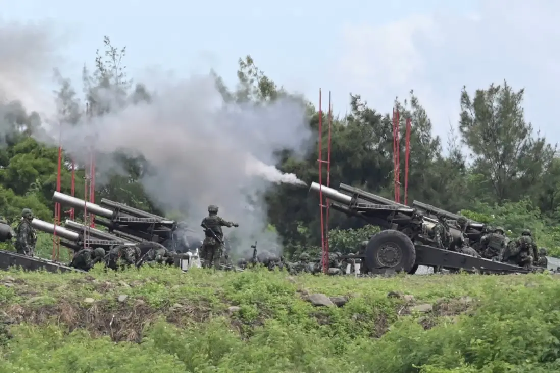 Taiwanese military soldiers fire howitzers during a live-fire anti-landing drill in Pingtung county, Taiwan