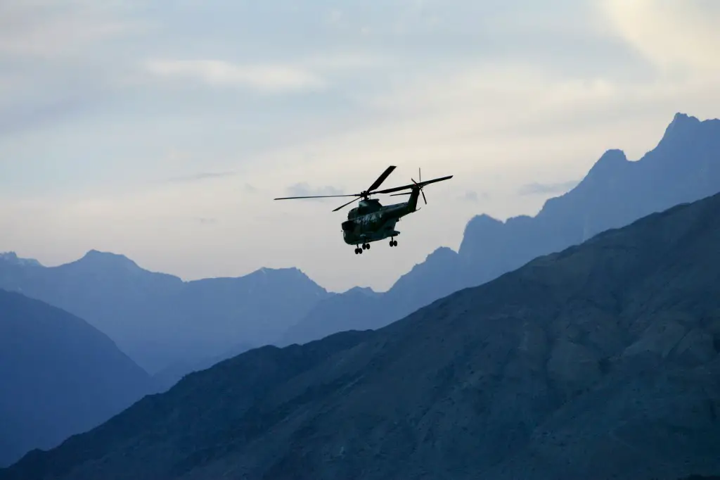 Military helicopter in flight in Hunza region of Karokoram Mountains, Pakistan