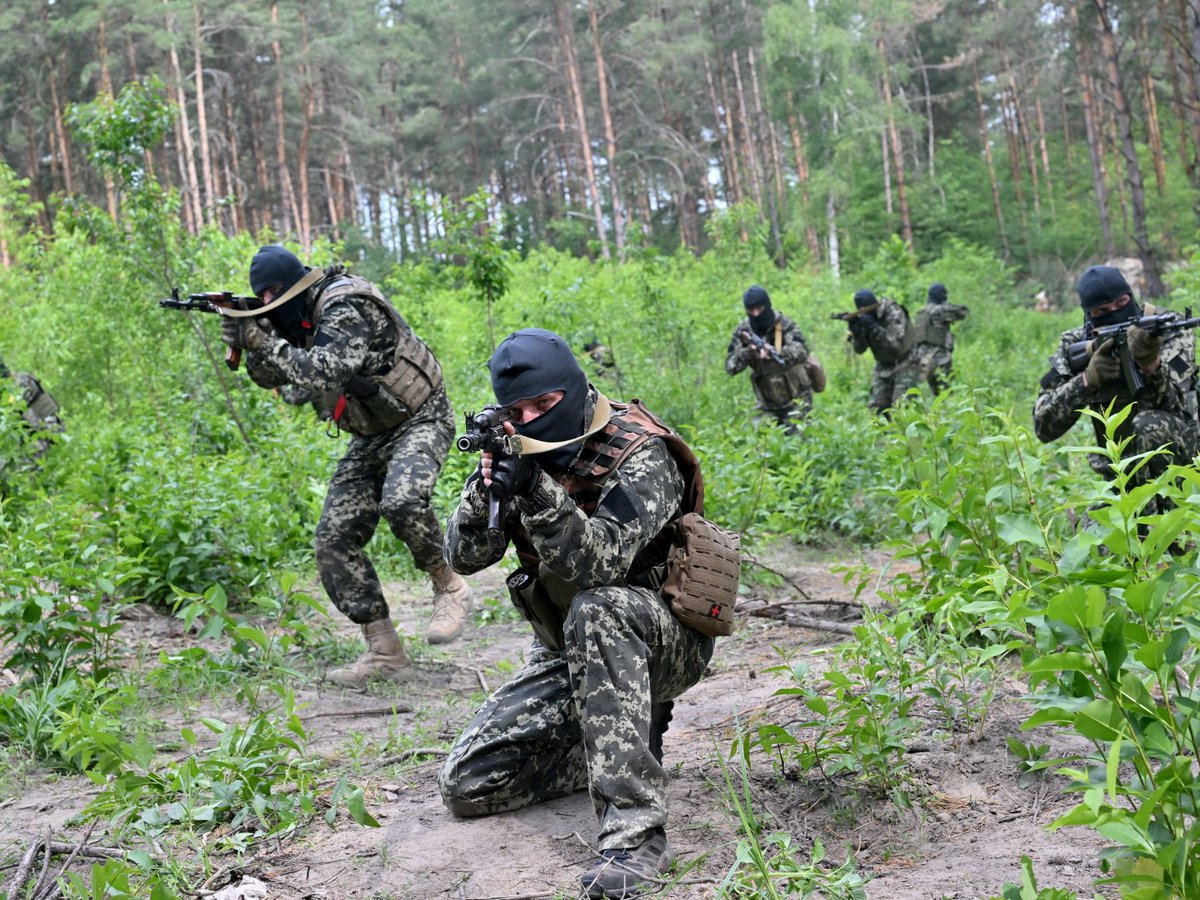 Fighters of the territorial defense unit, a support force to the regular Ukrainian army, take part in an exercise for the regular combat tactics