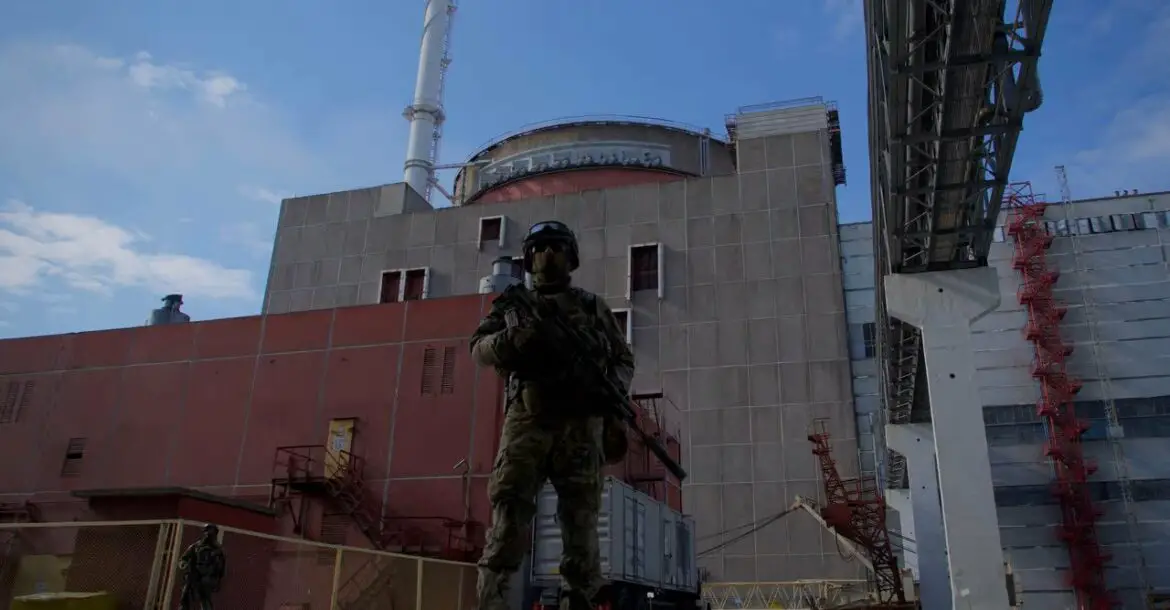 A soldier stands guard outside the Zaporizhzhia nuclear power plant, Ukraine