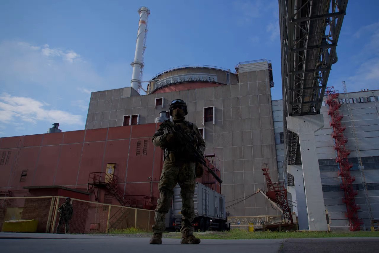 A soldier stands guard outside the Zaporizhzhia nuclear power plant, Ukraine
