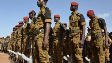 Burkinabe soldiers stand in line