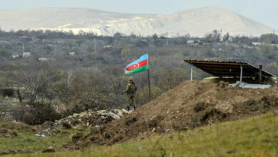 Azerbaijani soldier stands guard at a checkpoint on a road entering Fuzuli from Hadrut in Nagorno Karabakh