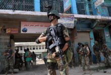 Pakistani soldiers patrol at an empty bazaar during a military operation against Taliban militants in North Waziristan