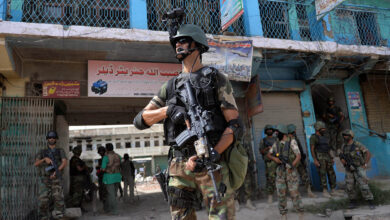Pakistani soldiers patrol at an empty bazaar during a military operation against Taliban militants in North Waziristan