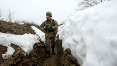 Ukrainian soldier patrolling a trench in eastern Ukraine.