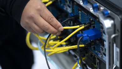 Technician checks a wire during a new computer network demonstration