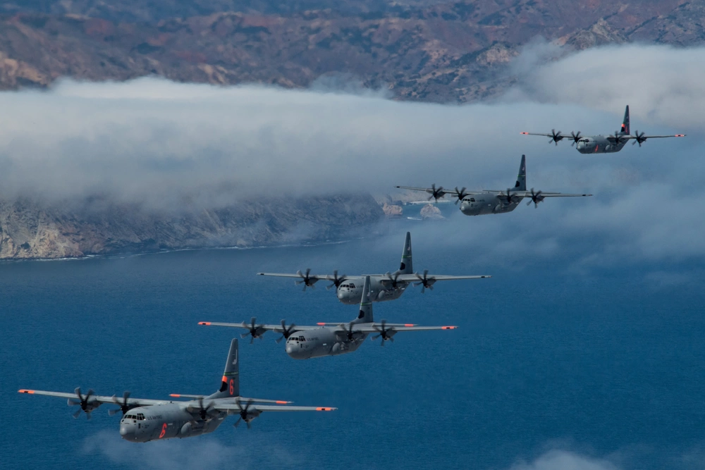 California Air National Guard C-130J Super Hercules aircraft fly in tight formation the Pacific Ocean, California