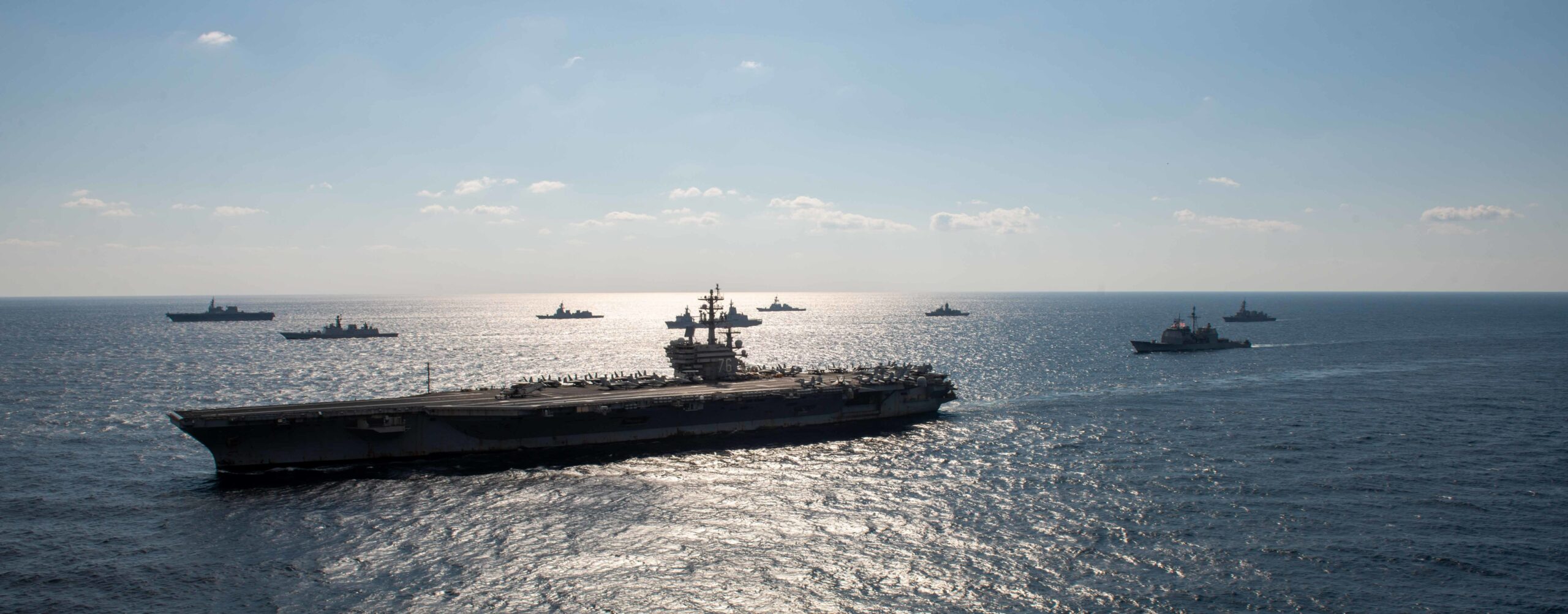 The US Navy’s only forward-deployed aircraft carrier, USS Ronald Reagan (CVN 76), steams in formation with ships from the Japan Maritime Self-Defense Force, Royal Australian Navy, and Indian Navy during Exercise Malabar 2022