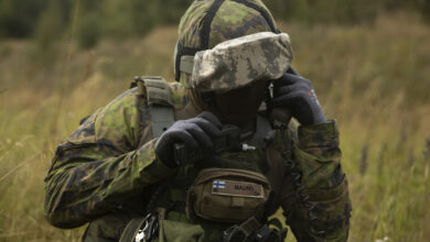 A Finnish Defence Force solider communicating with a radio.