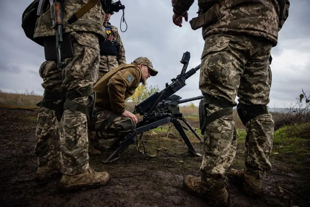 Ukrainian soldiers check their weapons at a position on the front line in eastern Ukraine's Donetsk region on Oct. 24, amid the Russian invasion of Ukraine