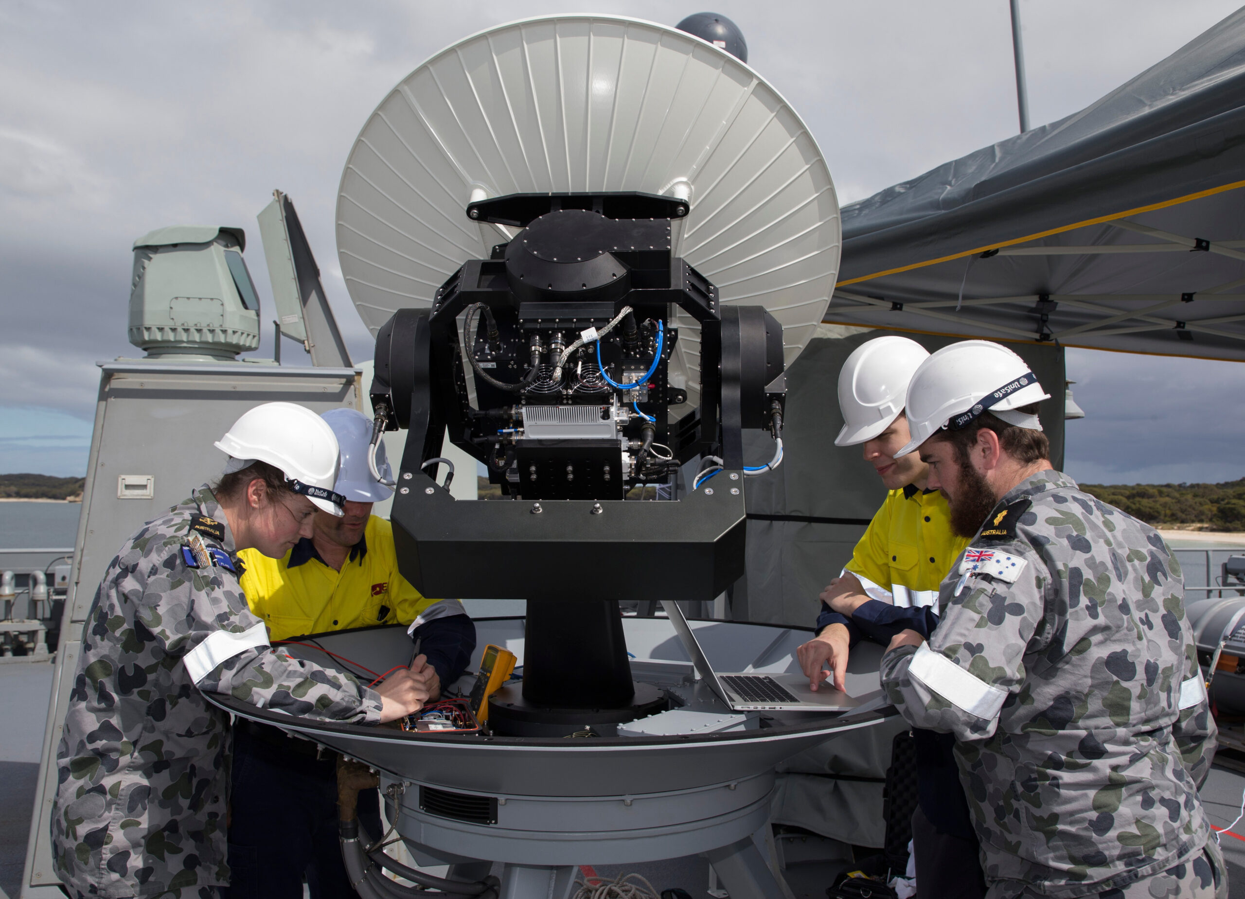Royal Australian Navy sailors assemble SATCOM for maritime WiFi connection.