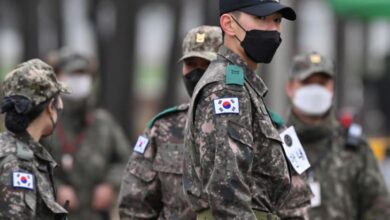 South Korean soldiers stand at the main gate of a military training unit in Yeoncheon