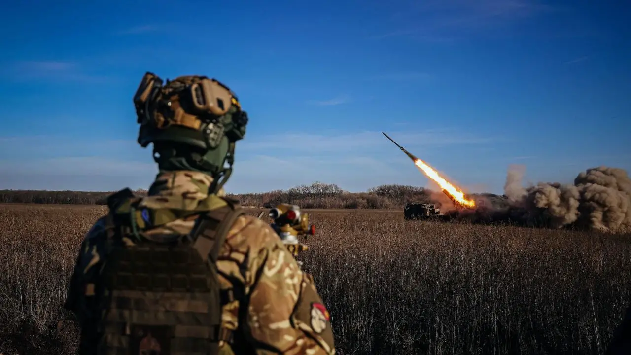 A Ukrainian soldier watches a self-propelled 220 mm multiple rocket launcher "Bureviy" firing towards Russian positions in eastern Ukraine
