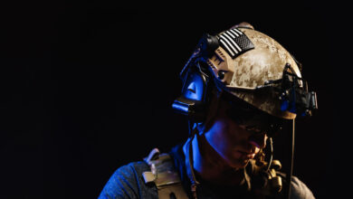 Portrait of special forces soldier in helmet and glasses in the dark