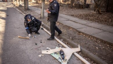 Ukrainian police officers inspect a downed Russian drone after a strike in northwestern Kyiv