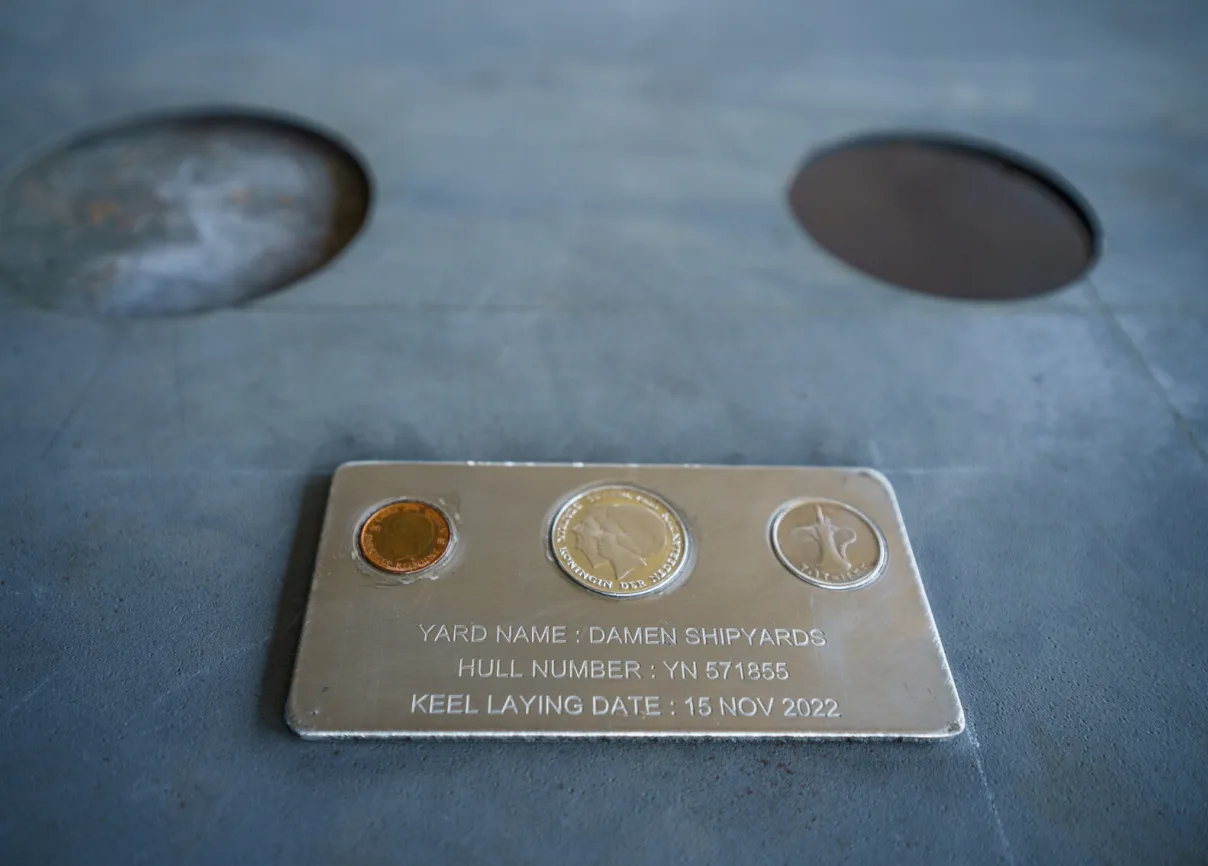 A Swedish Crown, a (former) Dutch Rijksdaalder and an Emirates Dirham on a steel plate of the Tug hull construction.