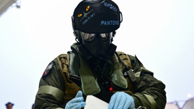 PACAF pilot prepares CBRN protective equipment at Kunsan Air Base, South Korea