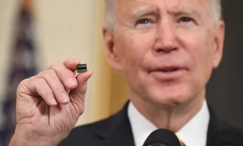 President Biden holds a semiconductor chip