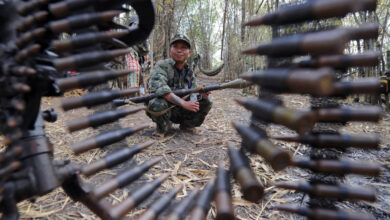 A Karen fighter holds a rocket launcher while standing guard at Oo Kray Kee village in Kayin state near the Thai-Myanmar border