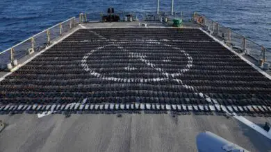 Thousands of AK-47 assault rifles sit on the flight deck of guided-missile destroyer USS The Sullivans during an inventory process, January 7, 2023