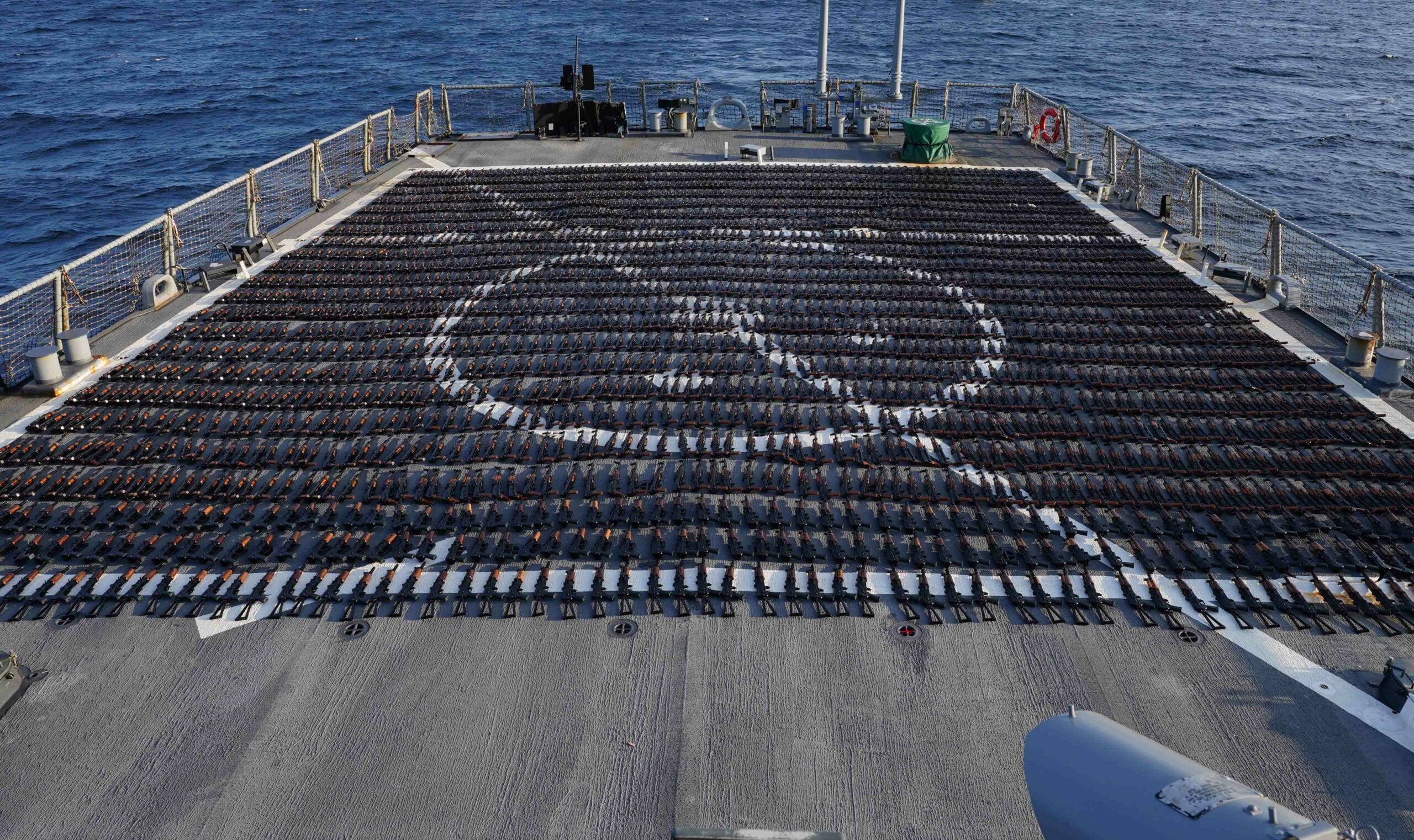 Thousands of AK-47 assault rifles sit on the flight deck of guided-missile destroyer USS The Sullivans during an inventory process, January 7, 2023
