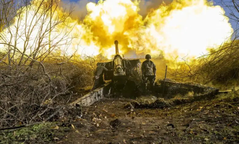 A Ukrainian soldier of an artillery unit fires towards Russian positions