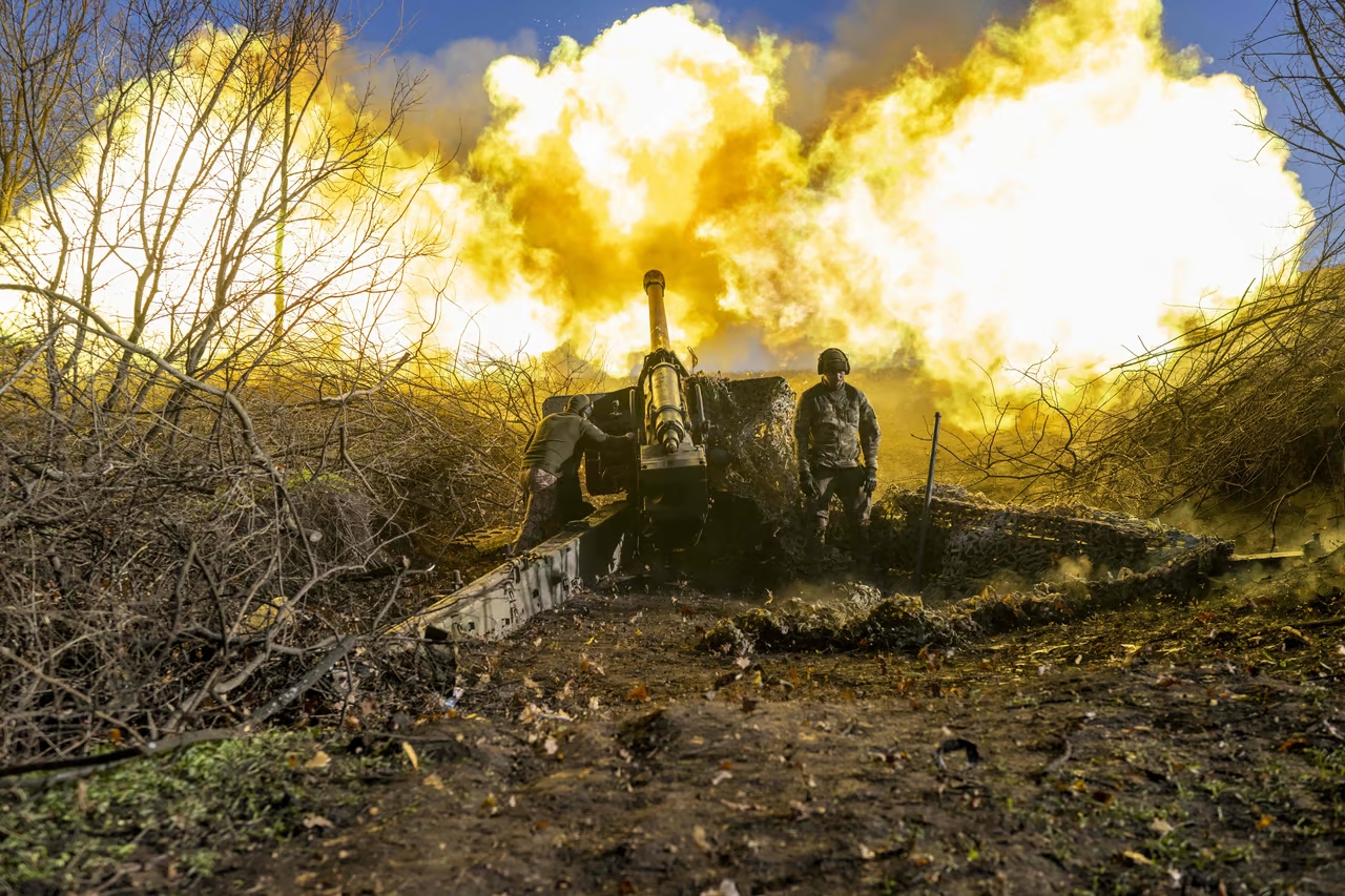 A Ukrainian soldier of an artillery unit fires towards Russian positions