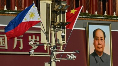 The national flags of the Philippines and China are seen together near the Tiananmen Gate