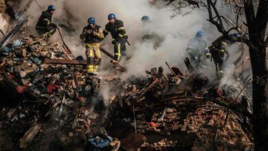 Ukrainian firefighters works on a destroyed building after a drone attack in Kyiv