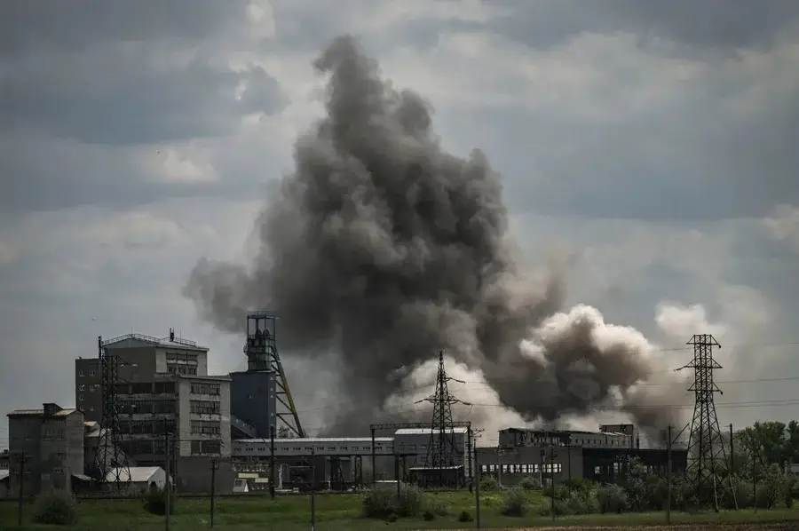 Smoke and debris ascend after a strike at a factory in the city of Soledar, in eastern Ukraine's Donbas region