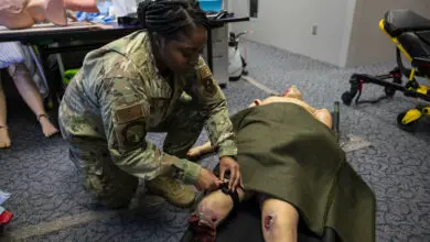 U.S. Air Force Tech. Sgt. Renique Carey, 49th Medical Group force health management noncommissioned officer in charge, applies a tourniquet on a test dummy at Holloman Air Force Base, New Mexico, Jan. 27, 2023. By using the Medic-X program, the 49th MDG ensures that non-patient-care career fields within the group receive proper training in case of large-scale emergencies. (U.S. Air Force photo by Airman 1st Class Isaiah Pedrazzini)