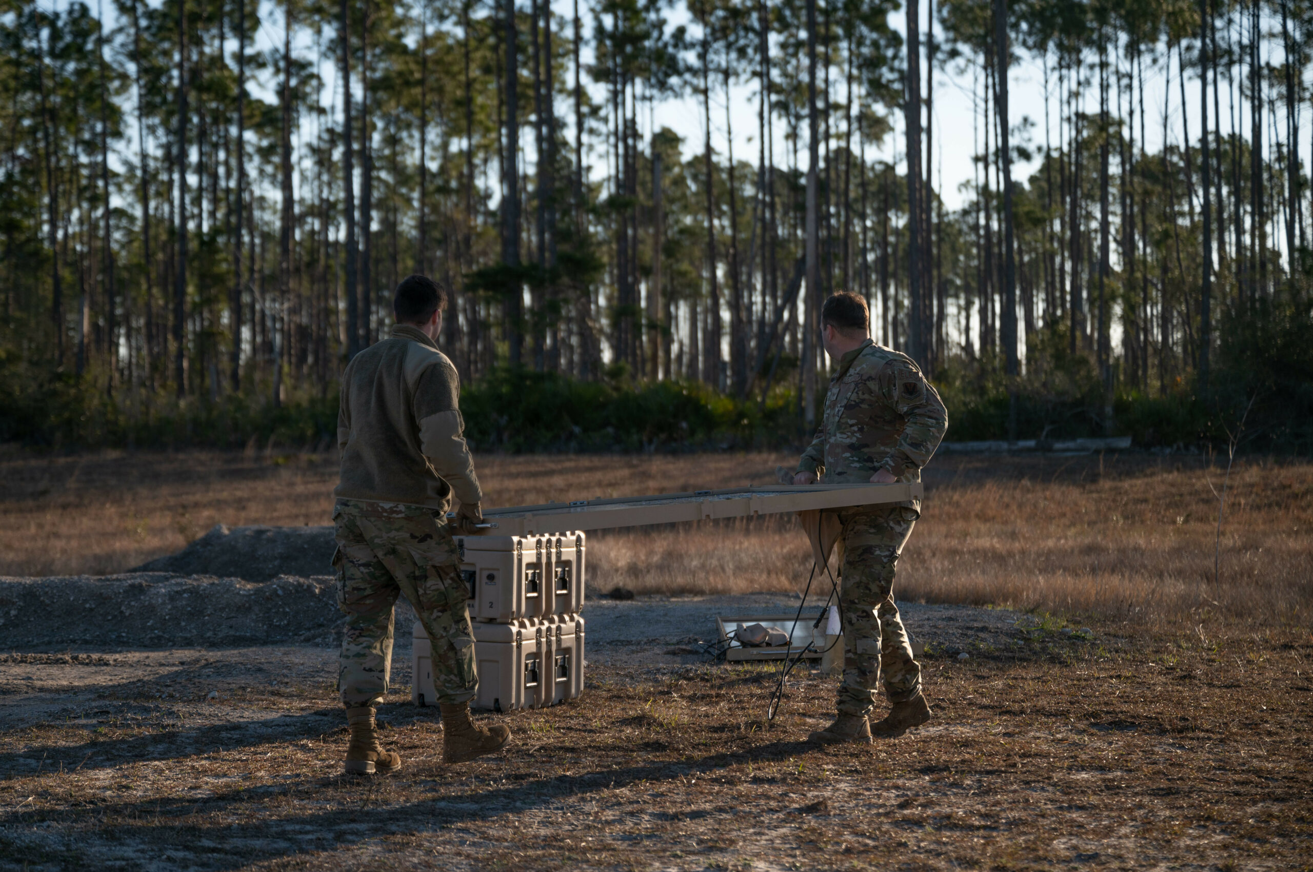 U.S. Airmen prepare to assemble an Expeditionary Airfield Lighting System (EALS-C) at Tyndall Air Force Base, Florida, Jan. 27, 2023. The proper setup, use and break down of the EALS-C system was taught to electrical systems Airmen from different Air Force installations in the new Mission Essential Equipment Training held at Tyndall AFB. (U.S. Air Force photo by Senior Airman Anabel Del Valle)