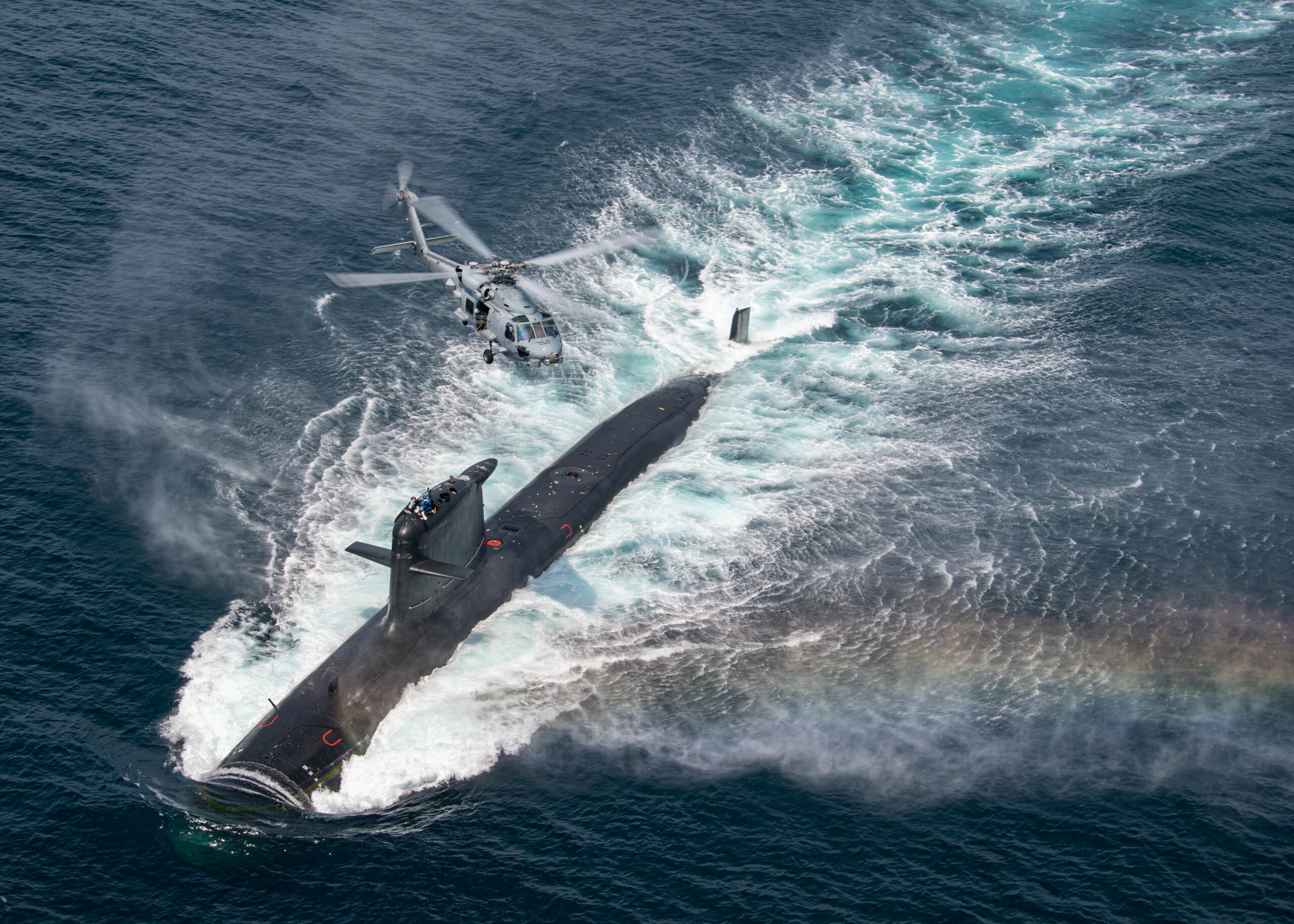 210816-N-GR718-0701 SAN DIEGO (Aug. 16, 2021) An MH-60R assigned to the “Seahawks'' of Helicopter Maritime Strike Squadron (HSM) 41 flies over a Chilean Navy Scorpene Class Submarine during Diesel-Electric Submarine Initiative Hoist Exercise 2021 (DESI HOISTEX). DESI is a multinational exercise designed to strengthen partnerships and enhance capabilities among partner nations. (U.S. Navy Photo by Mass Communication Specialist 2nd Class Chelsea D. Meiller)